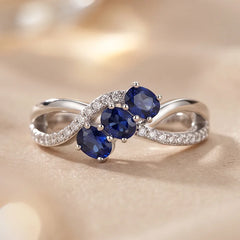 0.74 CT Oval Sapphire Three-Stone Infinity Pavé Ring