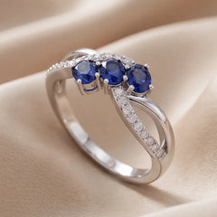 0.74 CT Oval Sapphire Three-Stone Infinity Pavé Ring