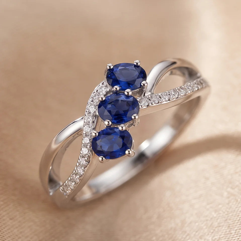 0.74 CT Oval Sapphire Three-Stone Infinity Pavé Ring